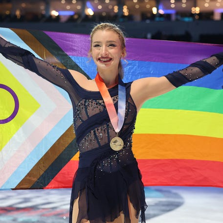 ST LOUIS, MISSOURI - JANUARY 09: Amber Glenn poses with a Pride flag after the Victory Ceremony after competing in the Championship Women's competition of the 2026 United States Figure Skating Championships at Enterprise Center on January 09, 2026 in St Louis, Missouri. (Photo by Matthew Stockman/Getty Images)