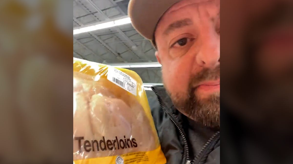 In a screenshot from a TikTok video, Jimmy Wrigg holds up a package of chicken that has been mispriced.
