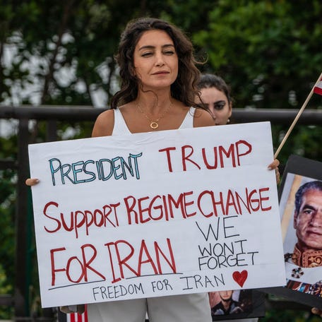 Protesters call on President Donald Trump to support regime change in Iran during a rally held Jan. 13, 2026, near his Mar-a-Lago estate in Palm Beach, Florida.