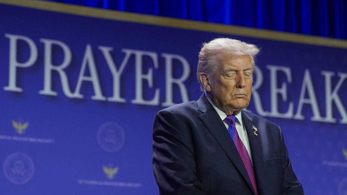President Donald Trump prays during a group prayer during the National Prayer Breakfast in Washington, D.C., U.S., February 5, 2026.