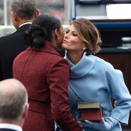 First Lady Melania Trump kisses former First Lady Michelle Obama at the presidential inauguration of Donald Trump at the U.S. Capitol on Jan. 20, 2017, in Washington, DC.