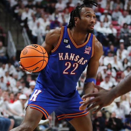 Kansas guard Darryn Peterson (22) dribbles the ball against Texas Tech guard Jazz Henderson (2) during their game at United Supermarkets Arena.