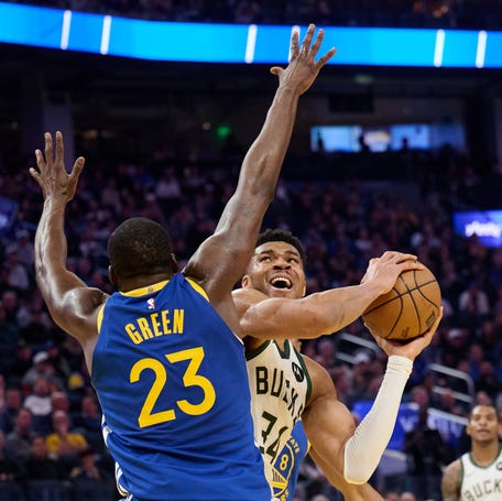 Milwaukee Bucks forward Giannis Antetokounmpo (34) shoots the ball against Golden State Warriors forward Draymond Green (23) during the second quarter at Chase Center.