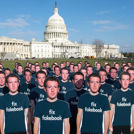 Cardboard cutouts of Facebook founder and CEO Mark Zuckerberg stand outside the U.S. Capitol in Washington, DC, in 2018.