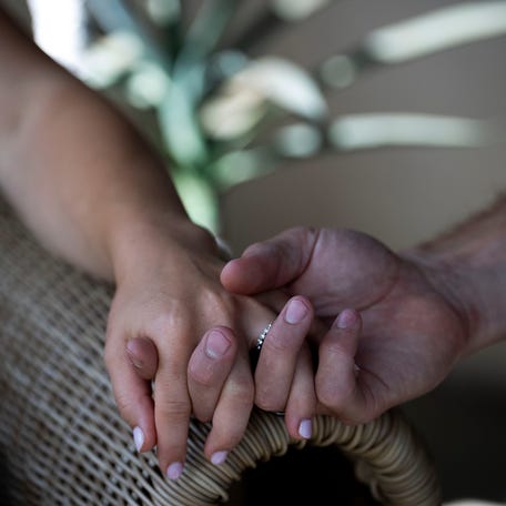 Shawn Johnson and Andrew East hold hands while sitting for a portrait with The Tennessean at their home in Nashville, Tenn., Wednesday, Sept. 3, 2025.