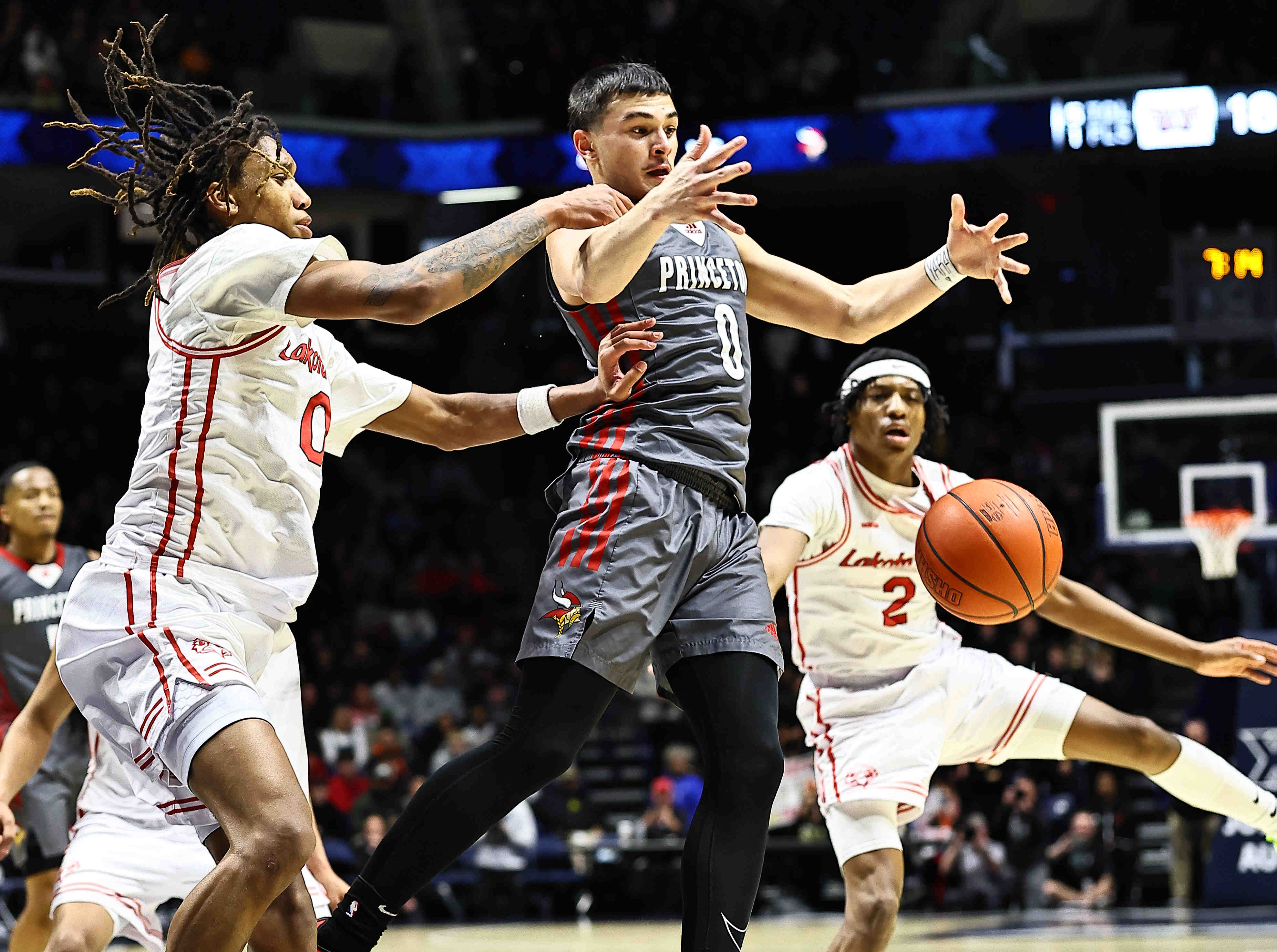 Lakota West's Bryce Curry (0) battles Princeton's Rognny Santiago (0) for a loose ball during their 58-53 win at Cintas Center, Friday, Feb. 6, 2026.