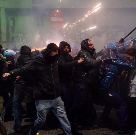 Fireworks explode during clashes between police officers and demonstrators who were trying to block a road leading to the Santa Giulia Arena, on the day of a protest against the environmental, economic and social impact of the Milano-Cortina 2026 Winter Olympics, in Milan, Italy on Feb. 7, 2026.