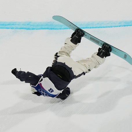 Hiroto Ogiwara of Japan crashes in the men's snowboarding big air final during the Milano Cortina 2026 Olympic Winter Games at Livigno Snow Park.