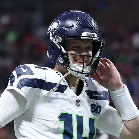 Sam Darnold #14 of the Seattle Seahawks reacts after throwing a touchdown pass during the fourth quarter against the Atlanta Falcons at Mercedes-Benz Stadium on December 07, 2025 in Atlanta, Georgia.
