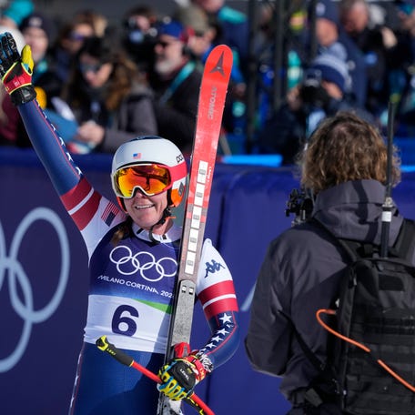 Feb 8, 2026; Cortina d'Ampezzo, Italy; Breezy Johnson of the United States celebrates in the finish area in the women's downhill alpine skiing race during the Milano Cortina 2026 Olympic Winter Games at Tofane Alpine Skiing Centre. Mandatory Credit: Michael Madrid-Imagn Images