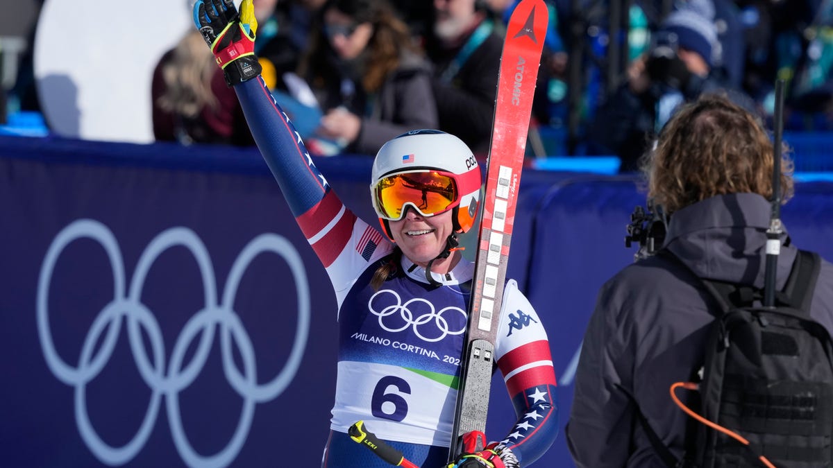 Feb 8, 2026; Cortina d'Ampezzo, Italy; Breezy Johnson of the United States celebrates in the finish area in the women's downhill alpine skiing race during the Milano Cortina 2026 Olympic Winter Games at Tofane Alpine Skiing Centre. Mandatory Credit: Michael Madrid-Imagn Images
