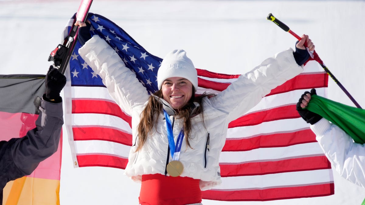 Breezy Johnson of the United States celebrates with her gold medal after winning the women's downhill alpine skiing race during the Milano Cortina 2026 Olympic Winter Games at Tofane Alpine Skiing Centre. Mandatory Credit: Michael Madrid-Imagn Images