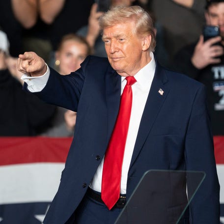 President Donald Trump points into the crowd during a rally at Horizon Events Center on Tuesday, Jan. 27, 2026 in Clive.