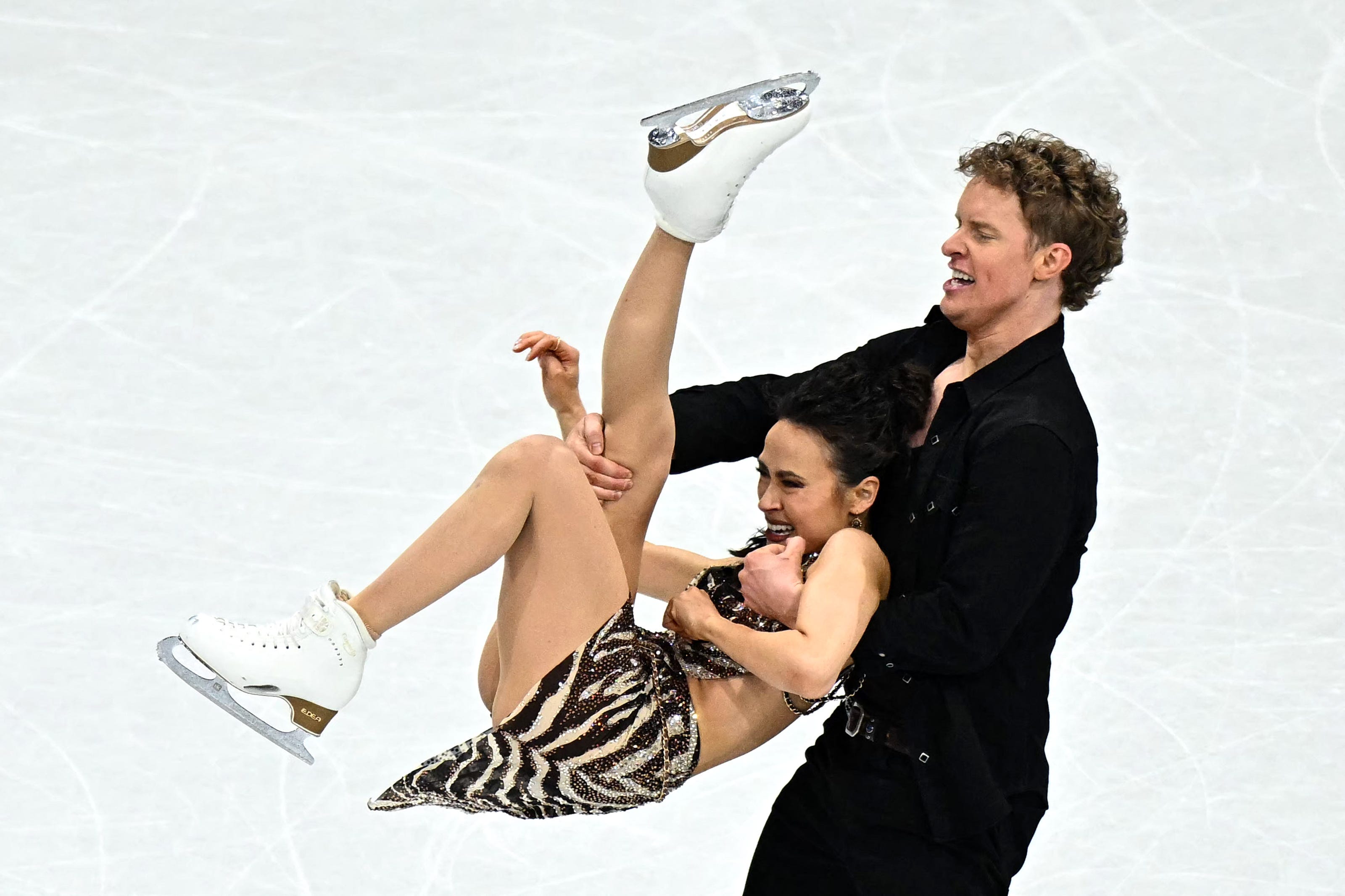 Skating last, Olympic ice dance gold-medal favorites Madison Chock and Evan Bates from Michigan just missed taking the lead after the rhythm dance.