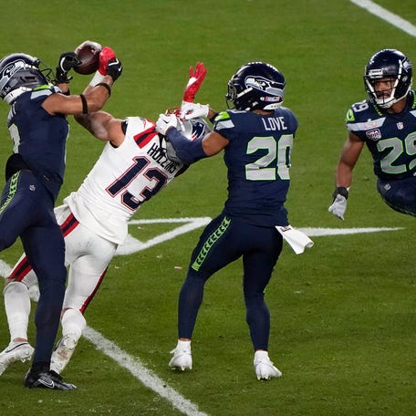 Coby Bryant of the Seattle Seahawks breaks up a pass intended for Mack Hollins of the New England Patriots while the Seahawks' Julian Love helps defend during the fourth quarter of Super Bowl LX on Feb. 2, 2026, at Levi's Stadium in Santa Clara, Calif.