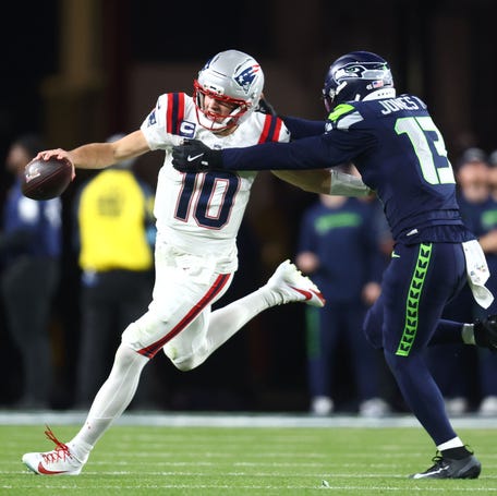 New England Patriots quarterback Drake Maye (10) runs against Seattle Seahawks linebacker Ernest Jones IV (13) during the third quarter of Super Bowl 60.