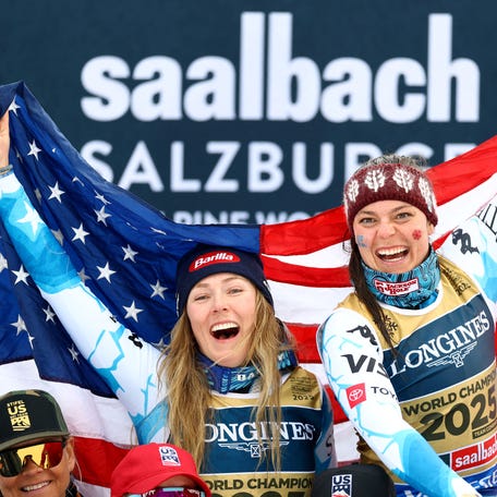 [US, Mexico & Canada customers only] Feb 11, 2025; Saalbach, AUSTRIA; Mikaela Shiffrin and Breezy Johnson of the United States celebrate on the podium after winning the women's team combined event at the FIS Alpine World Championships in Saalbach.