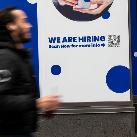 NEW YORK, NEW YORK - JANUARY 09: A 'now hiring' sign is displayed in a business's window in Manhattan on January 09, 2026, in New York City. (Photo by Spencer Platt/Getty Images)