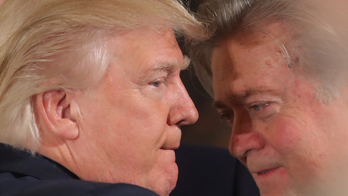 U.S. President Donald Trump talks to senior staff Steve Bannon during a swearing in ceremony for senior staff at the White House in Washington, DC January 22, 2017.