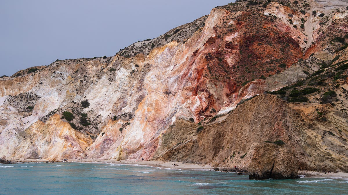The beach at Firiplaka, almost deserted in spring, is dominated by mineral cliffs in shades of yellow and ochre in Greece Cyclades islands, on Milos, May 7, 2025.