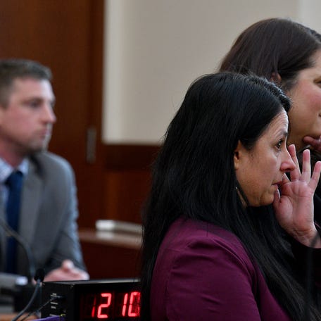 On day one of her trial on charges of assault and battery on a police officer and interference with police, former District 5 City Councilor Etel Haxhiaj, center, watches video footage with her attorney Elizabeth Halloran.