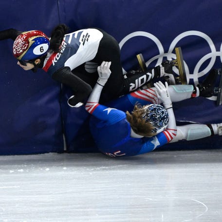 South Korea's Kim Gil-li and US' Corinne Stoddard crash in the short track speed skating mixed team relay semi-final during the Milano Cortina 2026 Winter Olympic Games at Milano Ice Skating Arena in Milan on Feb. 10, 2026.