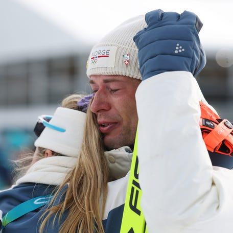 ANTHOLZ-ANTERSELVA, ITALY - FEBRUARY 10: Bronze medalist Sturla Holm Laegreid of Team Norway is embraced by Ingrid Landmark Tandrevold of Team Norway after the medal ceremony for the Men's 20km Individual on day four of the Milano Cortina 2026 Winter Olympic games at Anterselva Biathlon Arena on February 10, 2026 in Antholz-Anterselva, Italy. (Photo by Alexander Hassenstein/Getty Images)