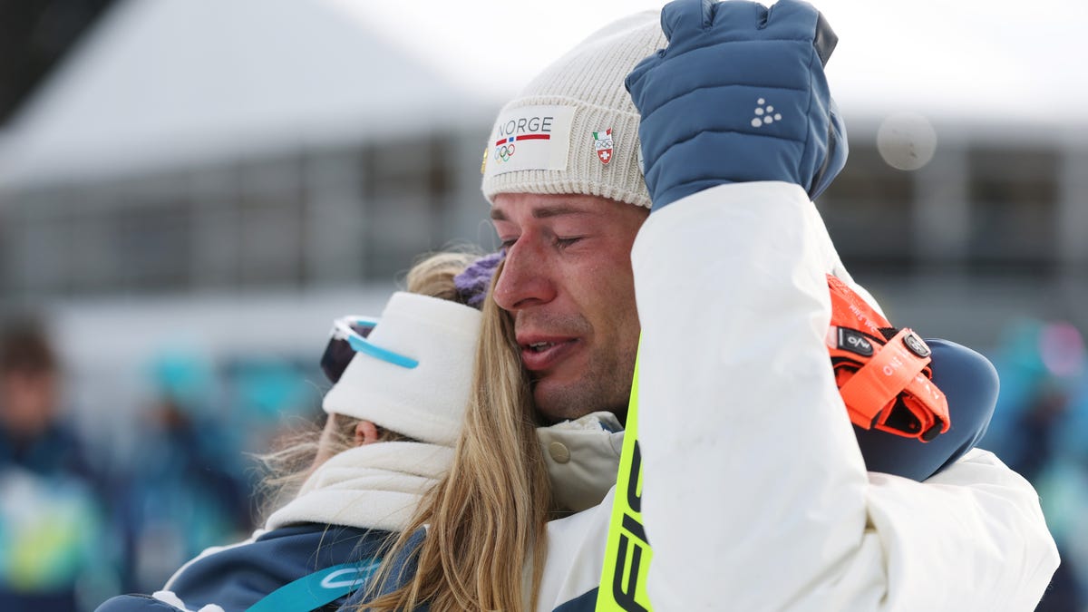 ANTHOLZ-ANTERSELVA, ITALY - FEBRUARY 10: Bronze medalist Sturla Holm Laegreid of Team Norway is embraced by Ingrid Landmark Tandrevold of Team Norway after the medal ceremony for the Men's 20km Individual on day four of the Milano Cortina 2026 Winter Olympic games at Anterselva Biathlon Arena on February 10, 2026 in Antholz-Anterselva, Italy. (Photo by Alexander Hassenstein/Getty Images)