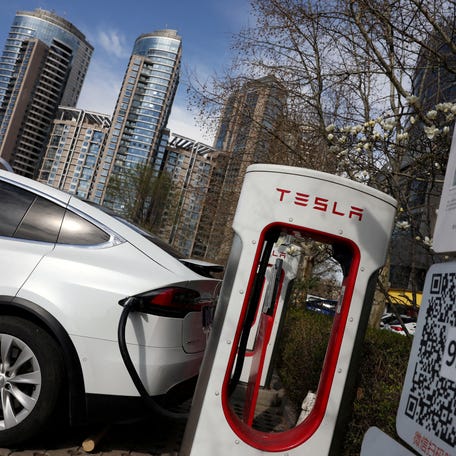 FILE PHOTO: A Tesla car charges at a Supercharger charging station of the electric vehicle (EV) maker in Beijing, China March 24, 2025. REUTERS/Florence Lo/File Photo