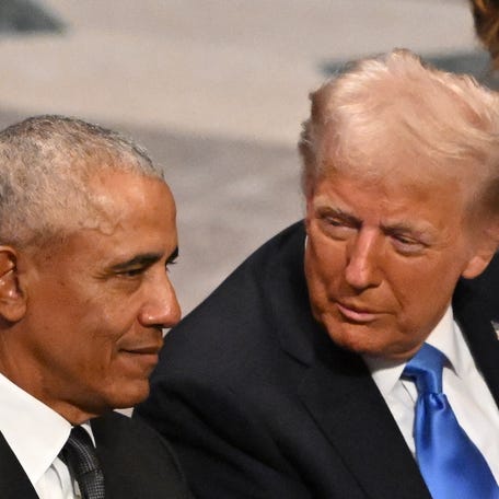 US President-elect Donald Trump speaks with former President Barack Obama as they attend the State Funeral Service for former US President Jimmy Carter at the Washington National Cathedral in Washington, DC, on January 9, 2025.