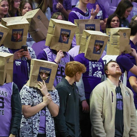 Feb 11, 2026; Manhattan, Kansas, USA; Kansas State Wildcats students wear grocery bags over their heads during the first half against he Cincinnati Bearcats at Bramlage Coliseum. Mandatory Credit: Scott Sewell-Imagn Images