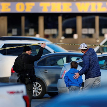 Police and family members stand outside Dennis M. Lynch Arena in Pawtucket after the Feb. 16 shooting.