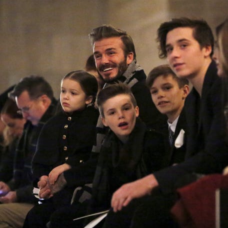 David Beckham sits in the front row at the Victoria Beckham fall/winter 2016 collection presentation with his children Harper, Cruz, Romeo and Brooklyn at New York Fashion Week Feb. 14, 2016.
