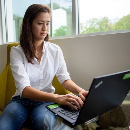 Sydney Teng, 24, poses for a portrait at the offices of Evergreen Health, the health care non-profit where she works. Teng is already investing in a 401(k), contributing 6% of her roughly $50,000 salary to the retirement savings account. The money deducted from her regular paycheck is invested in a target-date fund that eyes retirement around the age of 67. The fund is 90% invested in stocks.