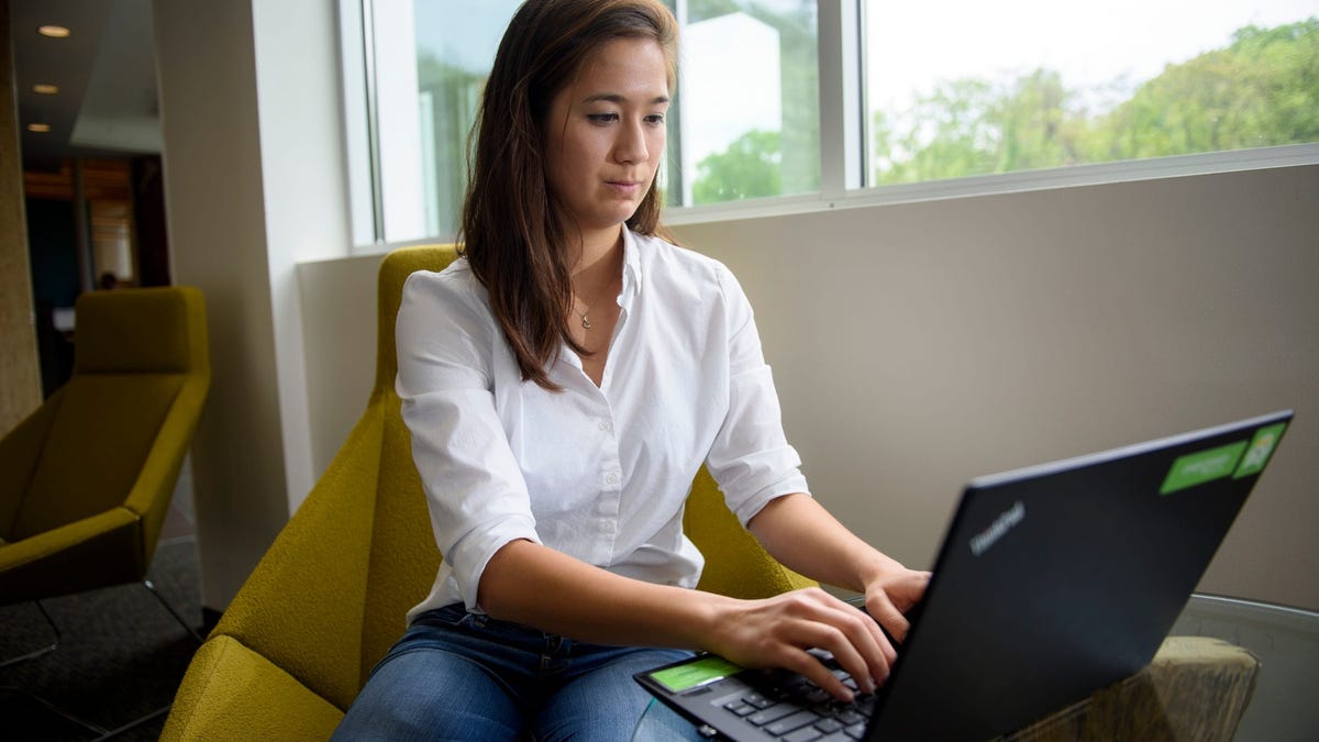Sydney Teng, 24, poses for a portrait at the offices of Evergreen Health, the health care non-profit where she works. Teng is already investing in a 401(k), contributing 6% of her roughly $50,000 salary to the retirement savings account. The money deducted from her regular paycheck is invested in a target-date fund that eyes retirement around the age of 67. The fund is 90% invested in stocks.