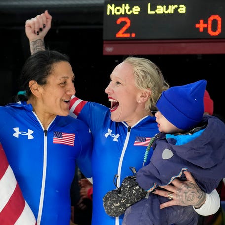 Elana Meyers Taylor and Kaillie Armbruster Humphries celebrate after winning gold and bronze, respectively in the monobob at the MIlano Cortina Winter Olympics on Feb. 16, 2026.