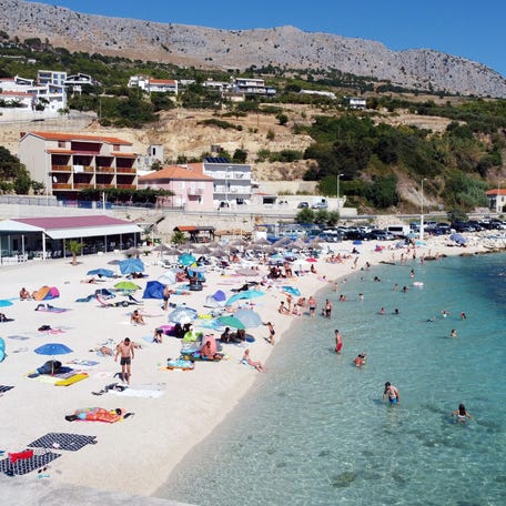 Crowds of people, including foreign tourists, enjoy the sun and the sea on August 21, 2020, in Split on the central Adriatic coast. - As United Kingdom removed Croatia from the list of "safe countries" to travel due to rising number of cases of COVID-19 throughout the country, many British tourists arrived at airport to return back to their country because of stricter measures when returning from Croatia. (Photo by Damir SENCAR / AFP) (Photo by DAMIR SENCAR/AFP via Getty Images)