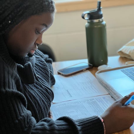 Sanii Stewart-McIver makes her way through three tax returns utilizing an instructional video and an IRS document for reference in order to fill out 1040 forms in a personal finance class at Winooski High School on February 21, 2023.    Photo Feb 21 2023 8 33 47 Am