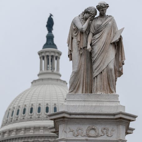 The Peace Monument frames the U.S. Capitol dome on a foggy day as the partial shutdown of the Department of Homeland Security continues, in Washington, D.C., on Feb. 17, 2026.