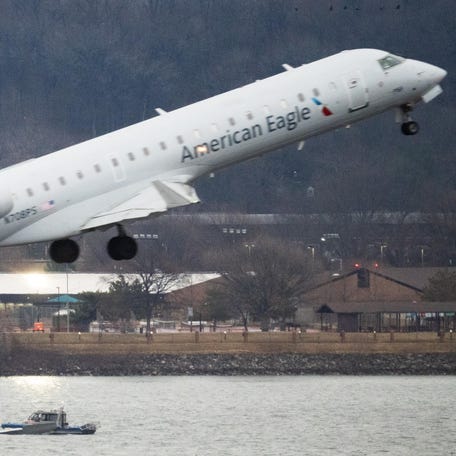 The wreckage of the American Airlines passenger jet is visible as flights take off at Ronald Reagan Washington National Airport on Jan. 31, days after it collided with an Army Black Hawk helicopter, resulting in the deaths of 67 people.