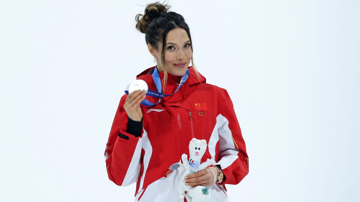 Silver medalist Ailing Eileen Gu of the People's Republic of China celebrates during the medal ceremony for the women's big air final during the Milano Cortina 2026 Olympic Winter Games at Livigno Snow Park.