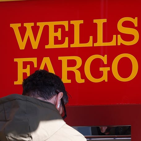 A customer uses an ATM at a Wells Fargo Bank on January 14, 2026, in San Francisco, California. Wells Fargo has agreed to pay a $56.85 million to resolve a class action lawsuit.