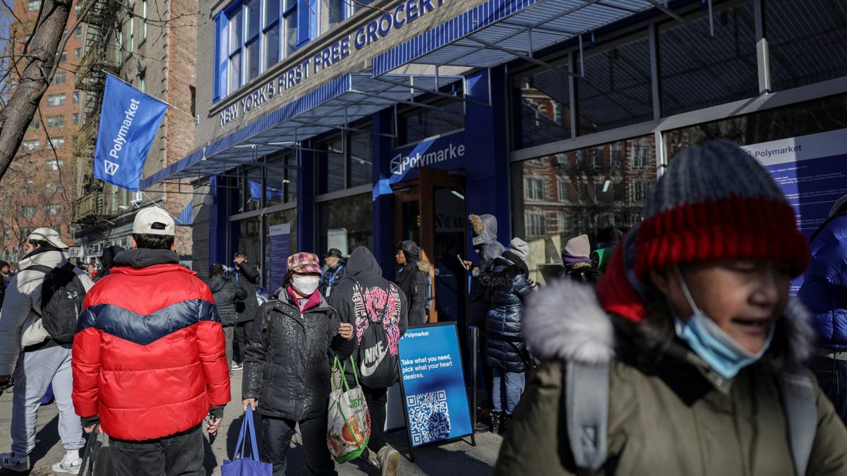 Shoppers carry groceries outside Polymarket in New York City, U.S., February 13, 2026. REUTERS/Jeenah Moon