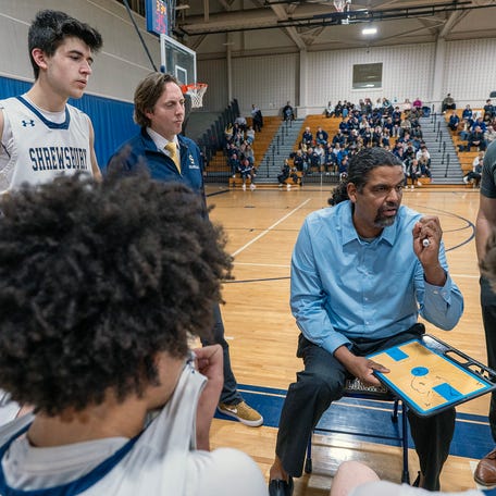 Shrewsbury High School head boys’ basketball coach Adrian Machado talks to the team during a time out against St. Paul Feb. 18.