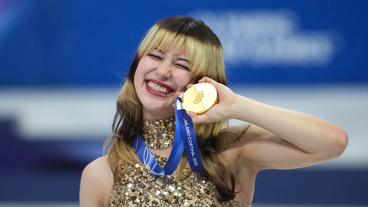 Feb 19, 2026; Milan, Italy; Alysa Liu of the United States celebrates with the gold medal in the women's free skate during the Milano Cortina 2026 Olympic Winter Games at Milano Ice Skating Arena. Mandatory Credit: James Lang-Imagn Images