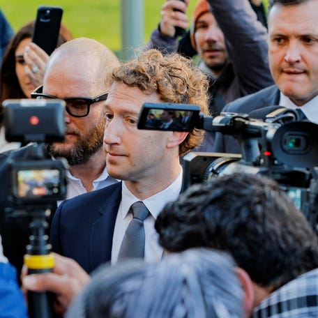 Meta CEO Mark Zuckerberg speaks to reporters as he arrives to testify in a trial in Los Angeles on Feb. 18, 2026. The trial seeks to determine whether social media platforms like Facebook and Instagram are "defective" products that lure teens and even young children to their sites, leading to negative consequences and addiction.