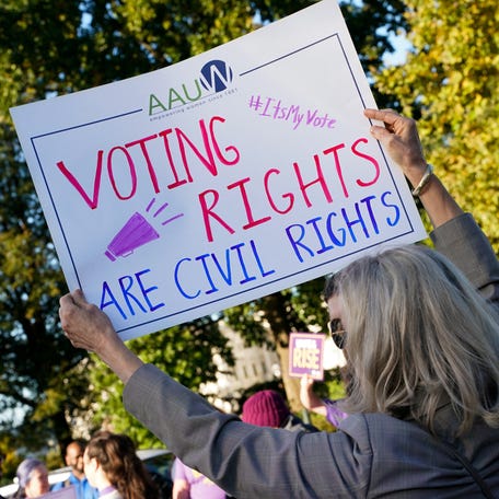 People protest on the day the Supreme Court hears arguments regarding the composition of Louisiana electoral districts, in Washington, D.C., on Oct. 15, 2025.