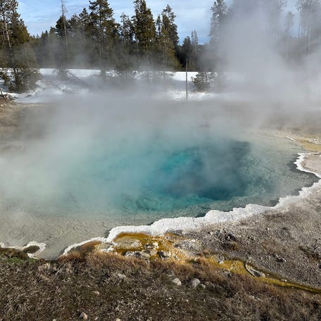 Steam rises from deep-blue Silex Spring.