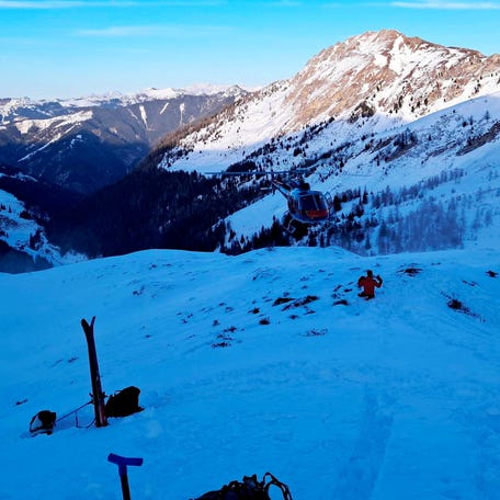 A helicopter hovers near the site where four skiers were killed in an avalanche in the Pongau district, Austria, January 17, 2026.