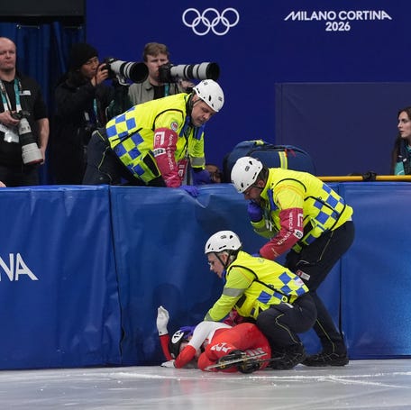 Kamila Sellier of Poland is treated by medical personnel during the women's short track speed skating 1,500m quarterfinals.